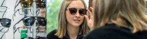 trying on sunglasses