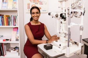 optometrist sitting at a desk